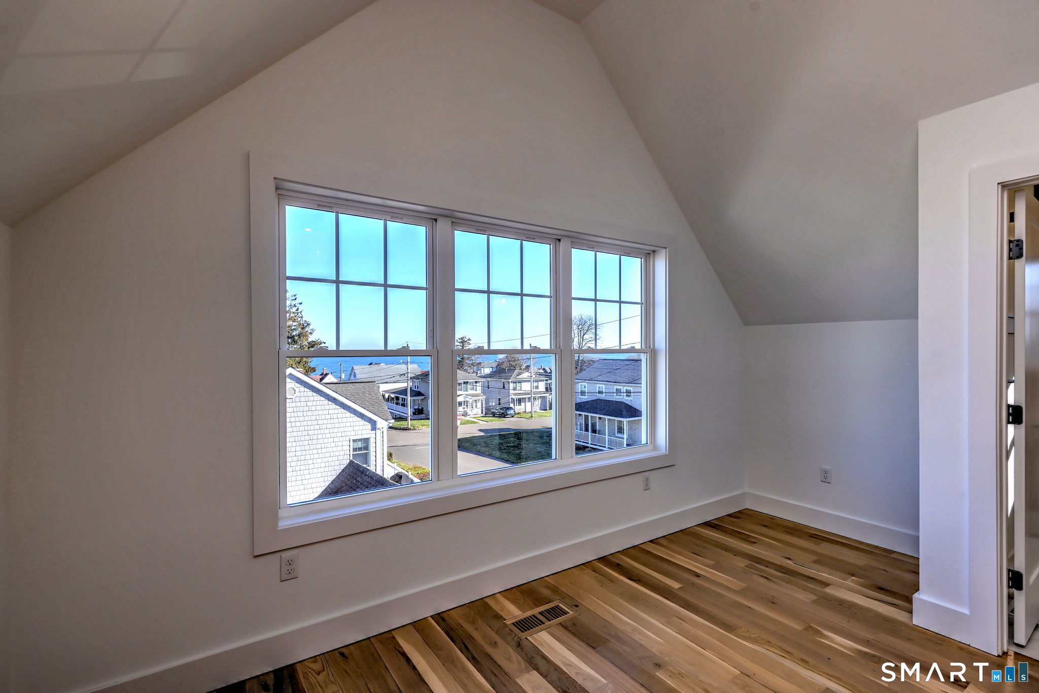 12 Usher Street Milford, CT 06460 - Photo 42 of 46 a view of an empty room with wooden floor and a window