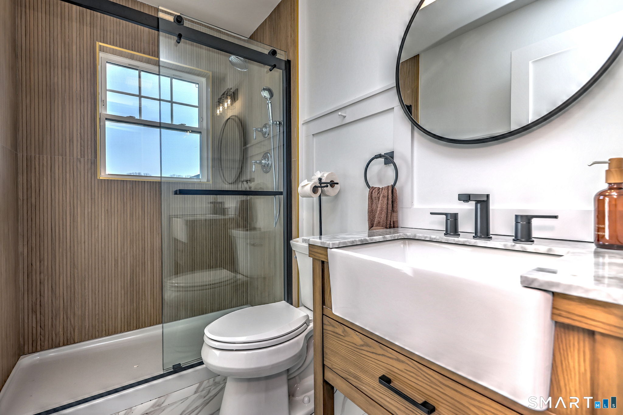 12 Usher Street Milford, CT 06460 - Photo 43 of 46 a bathroom with a sink a toilet and a mirror