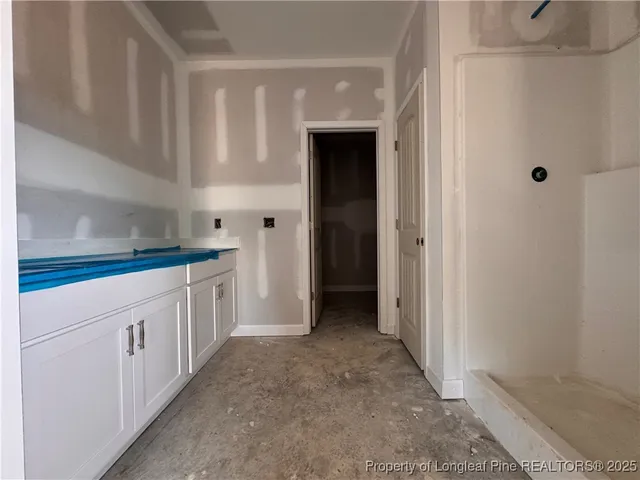 a kitchen with white cabinets and white appliances