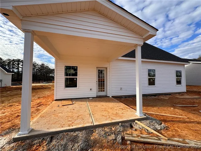 a view of house with backyard