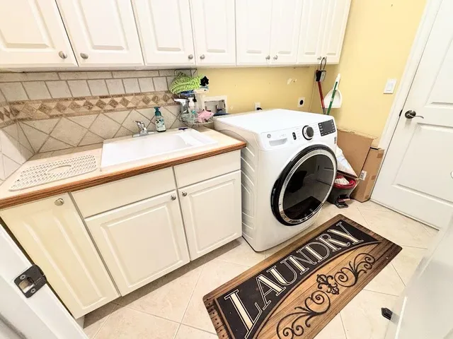 a spacious bathroom with a tub sink and mirror