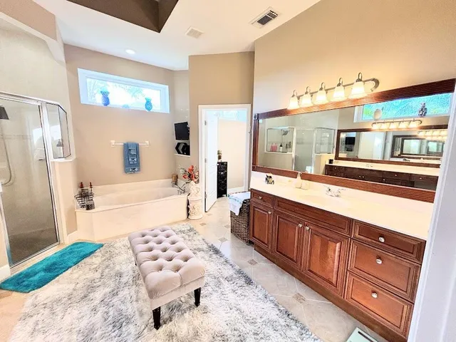 a bedroom with furniture window and flat screen tv