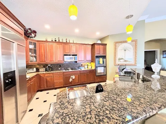 a front view of a house with a yard and potted plants