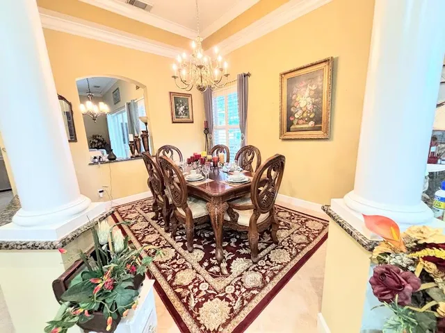 a view of a dining room with furniture and chandelier