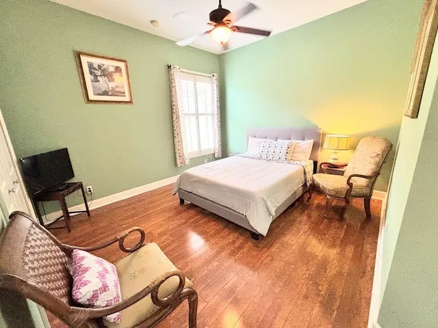 a dining room with furniture and a floor to ceiling window