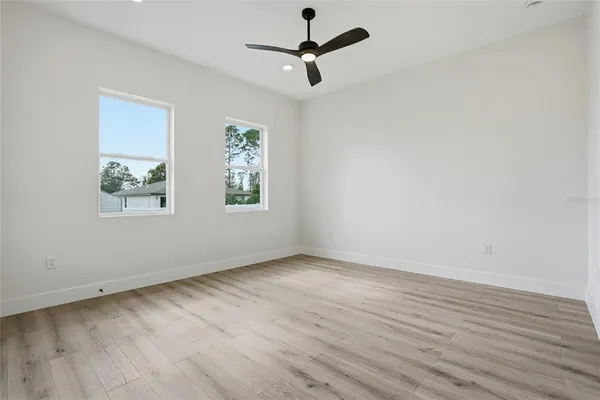 a view of an empty room with wooden floor