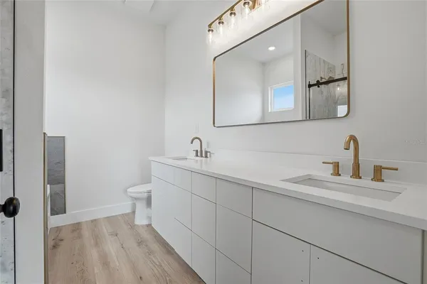 a bathroom with a double vanity sink mirror and