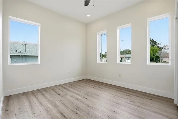 a view of an empty room with wooden floor