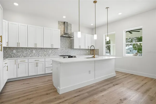 a kitchen with kitchen island white cabinets and white appliances