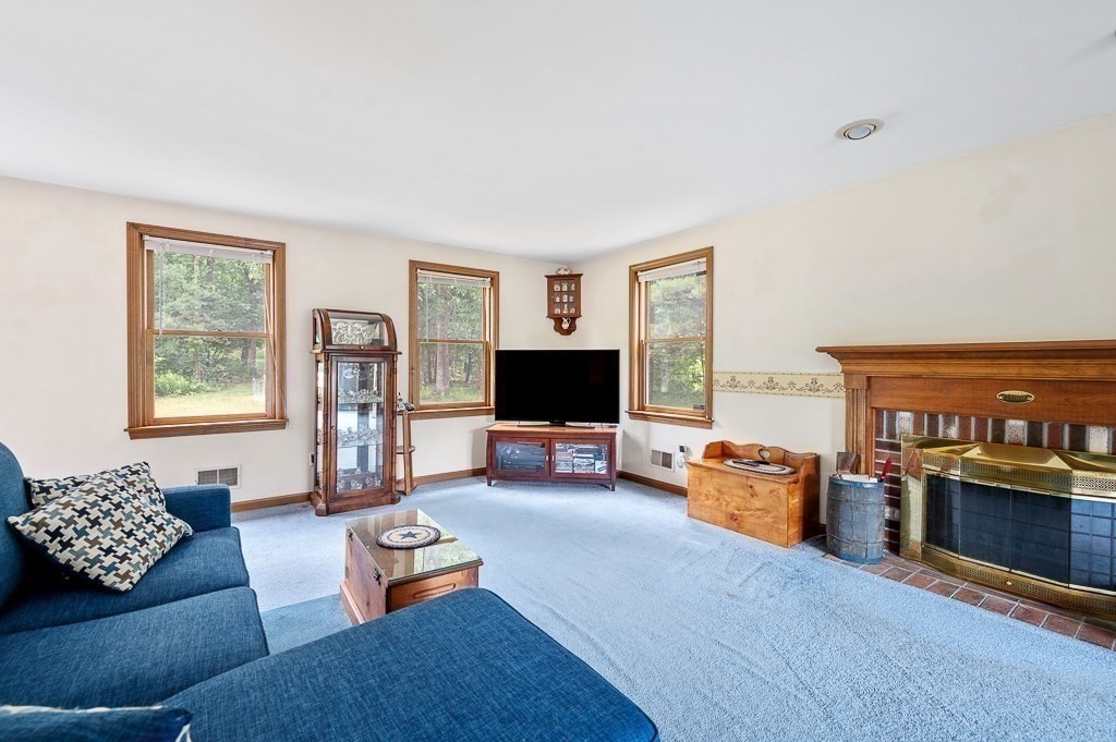 65 Lancaster Road Shirley, MA 01464 - Photo 11 of 42 a living room with furniture and a flat screen tv