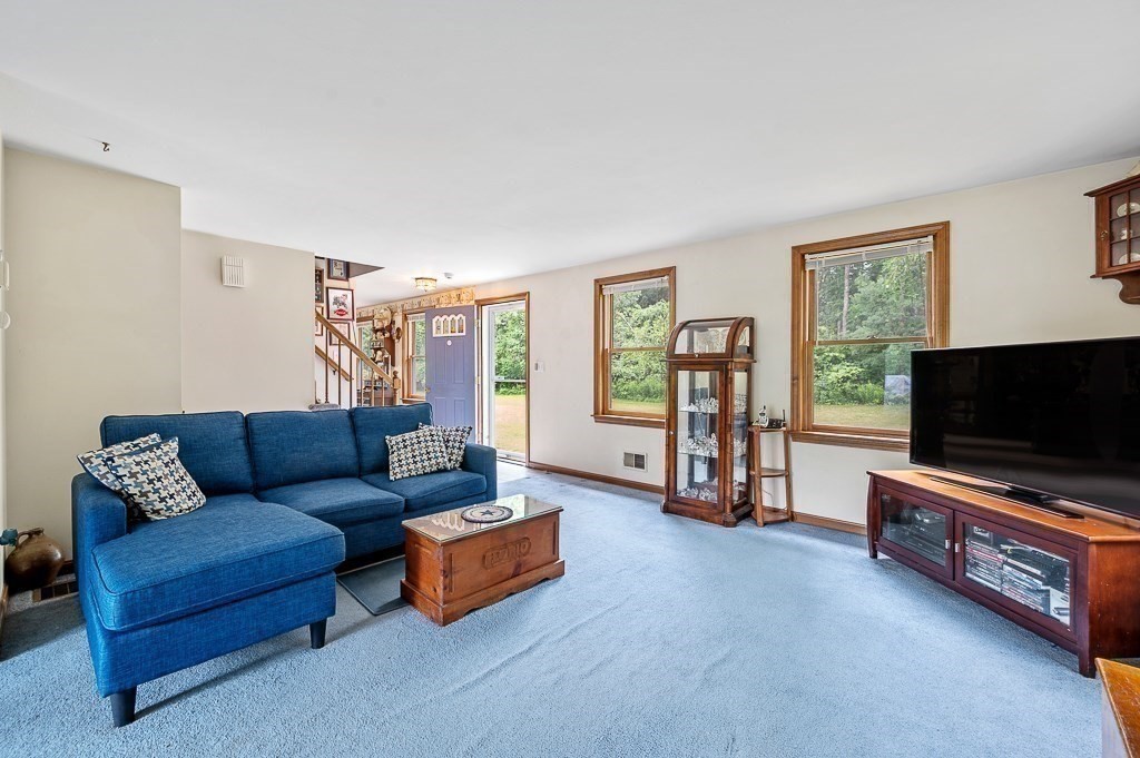 65 Lancaster Road Shirley, MA 01464 - Photo 12 of 42 a living room with furniture and a flat screen tv