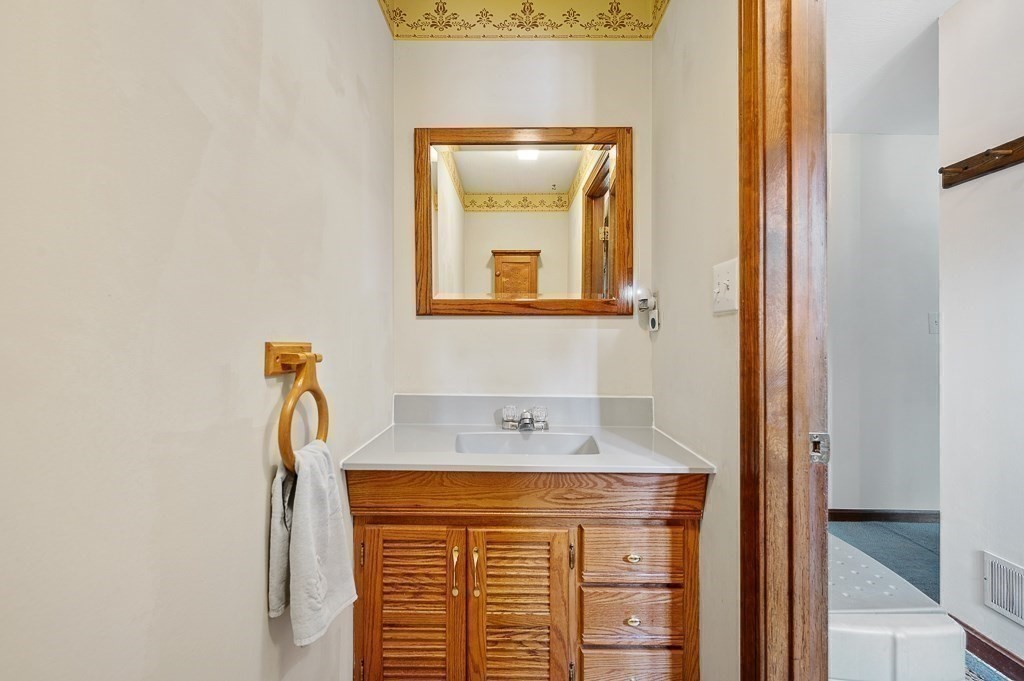 65 Lancaster Road Shirley, MA 01464 - Photo 16 of 42 a bathroom with a sink and a mirror