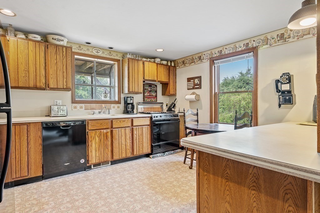 65 Lancaster Road Shirley, MA 01464 - Photo 18 of 42 a kitchen with a sink stove and refrigerator