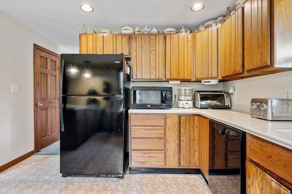 65 Lancaster Road Shirley, MA 01464 - Photo 19 of 42 a kitchen with a refrigerator and cabinets