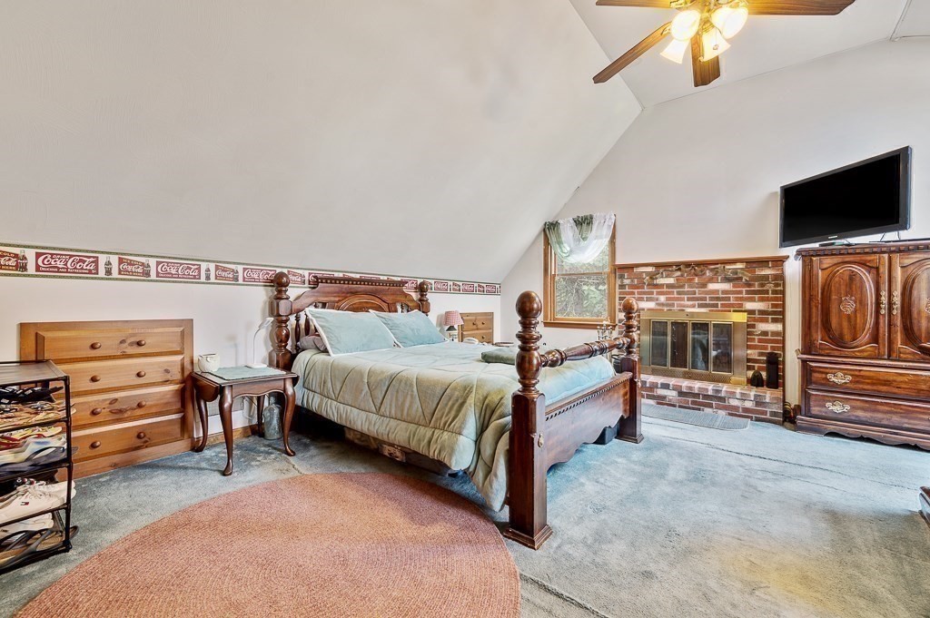65 Lancaster Road Shirley, MA 01464 - Photo 23 of 42 a spacious bedroom with a bed and flat tv screen on the dresser
