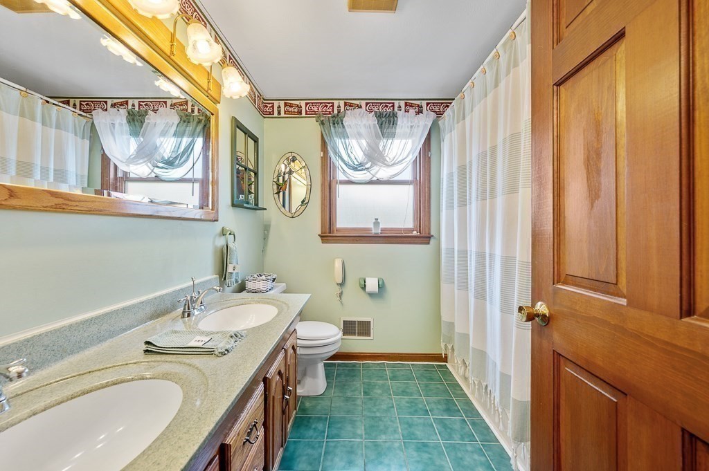 65 Lancaster Road Shirley, MA 01464 - Photo 24 of 42 a bathroom with a granite countertop sink a mirror a vanity and a shower