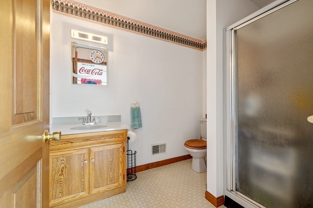 65 Lancaster Road Shirley, MA 01464 - Photo 27 of 42 a bathroom with a sink a toilet and shower