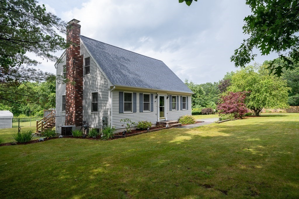 65 Lancaster Road Shirley, MA 01464 - Photo 3 of 42 a front view of a house with a garden