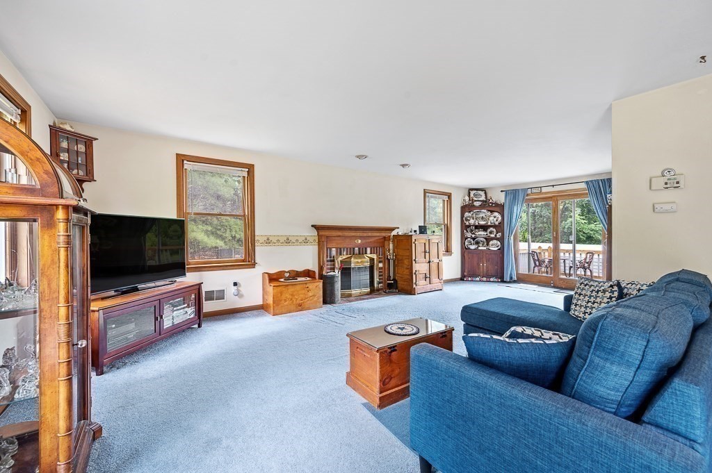 65 Lancaster Road Shirley, MA 01464 - Photo 10 of 42 a living room with furniture and a flat screen tv