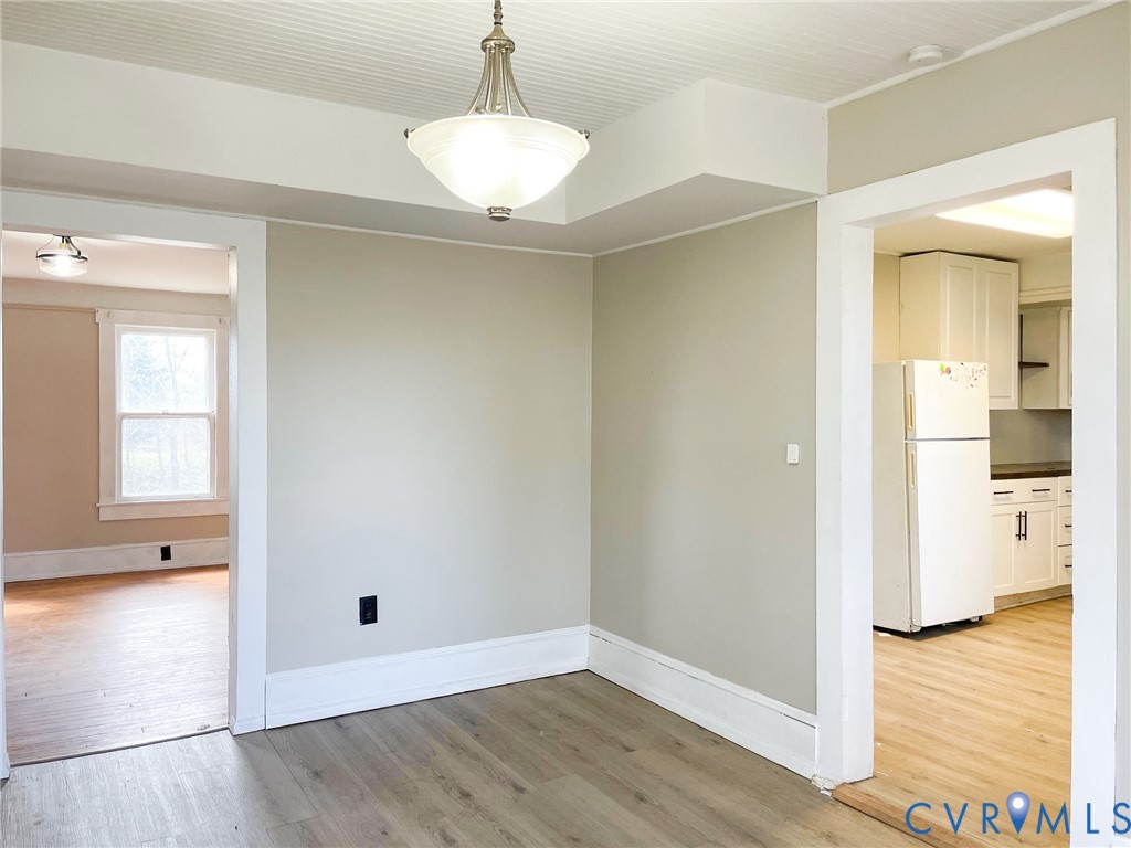 1016 Court Street Victoria, VA 23974 - Photo 12 of 29 a view of an empty room with wooden floor and a window