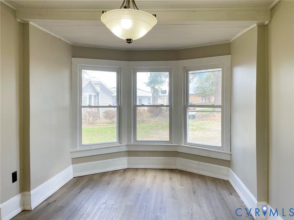 1016 Court Street Victoria, VA 23974 - Photo 13 of 29 an empty room with wooden floor and windows
