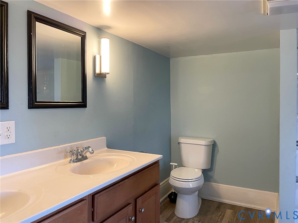 1016 Court Street Victoria, VA 23974 - Photo 21 of 29 a bathroom with a toilet a sink and mirror