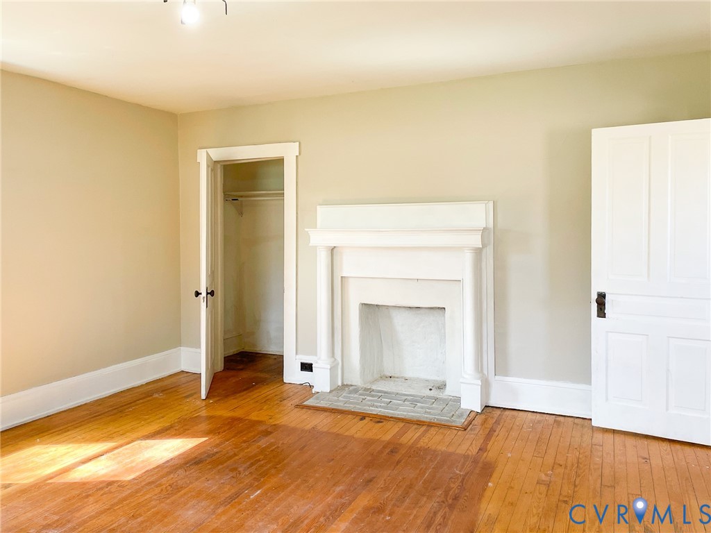 1016 Court Street Victoria, VA 23974 - Photo 5 of 29 a view of empty room with wooden floor and fan