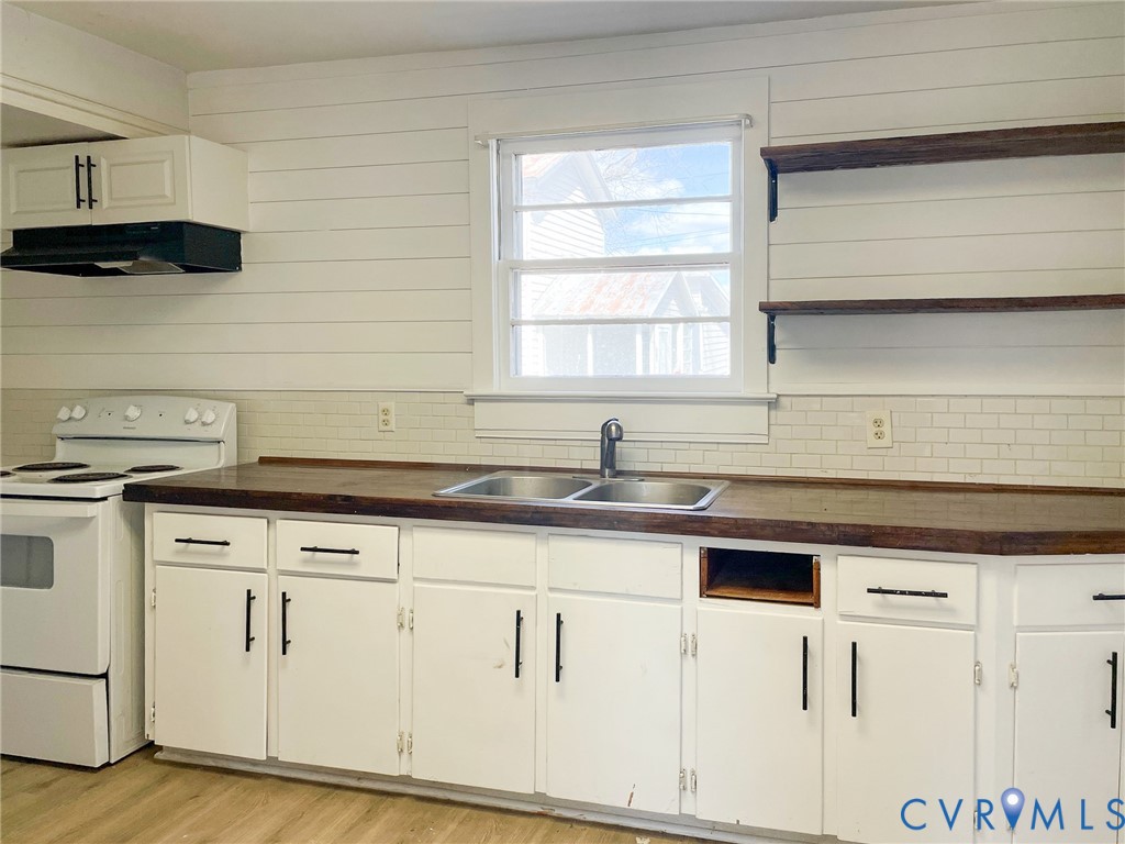 1016 Court Street Victoria, VA 23974 - Photo 8 of 29 a kitchen with granite countertop white cabinets and white appliances