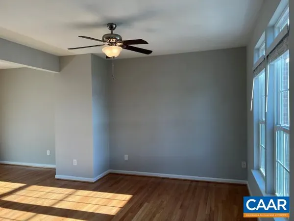 a view of a livingroom with wooden floor and a window