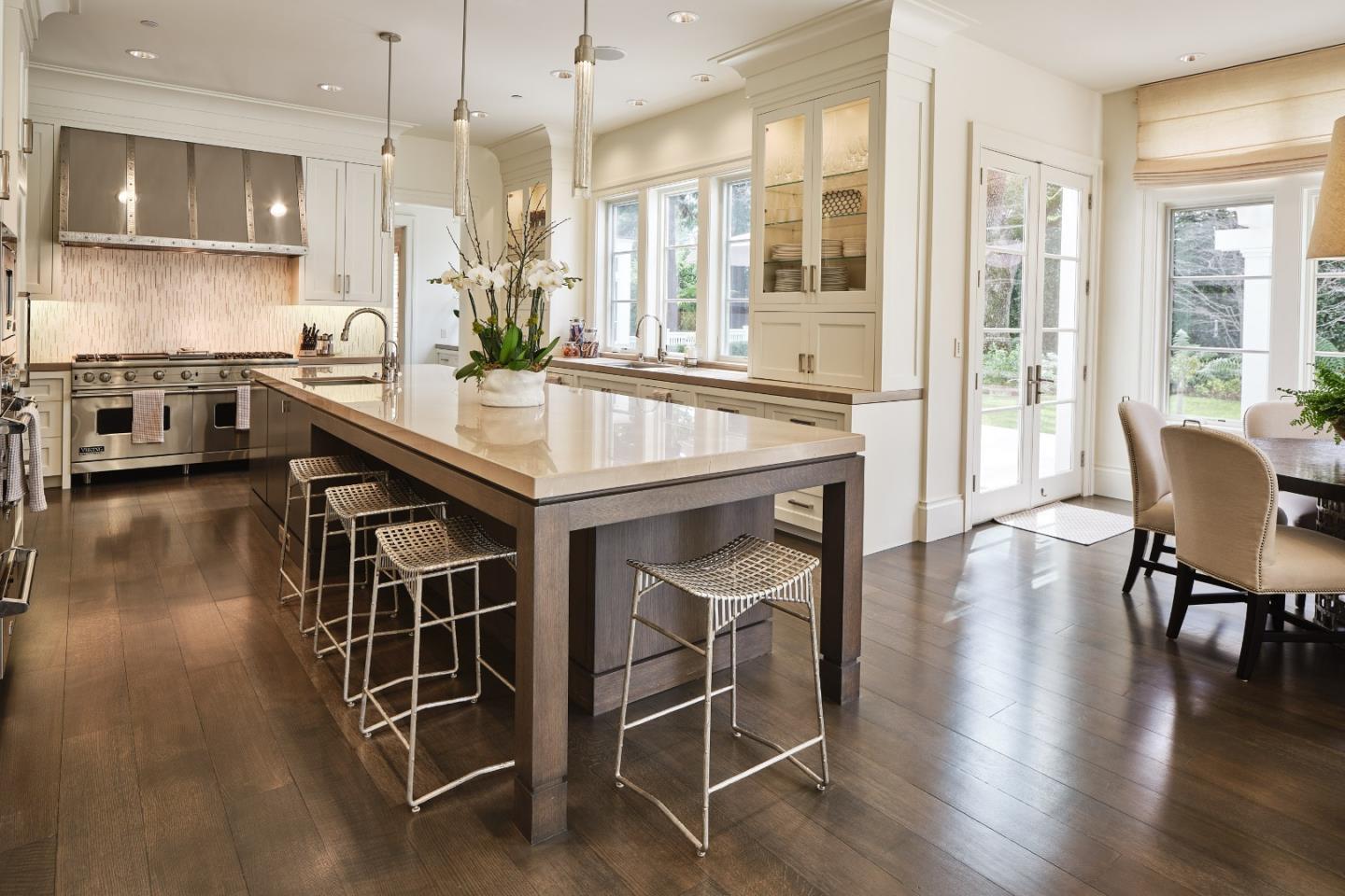 138 Almendral Avenue Atherton, CA 94027 - Photo 12 of 44 a kitchen with stainless steel appliances a dining table chairs and wooden floor