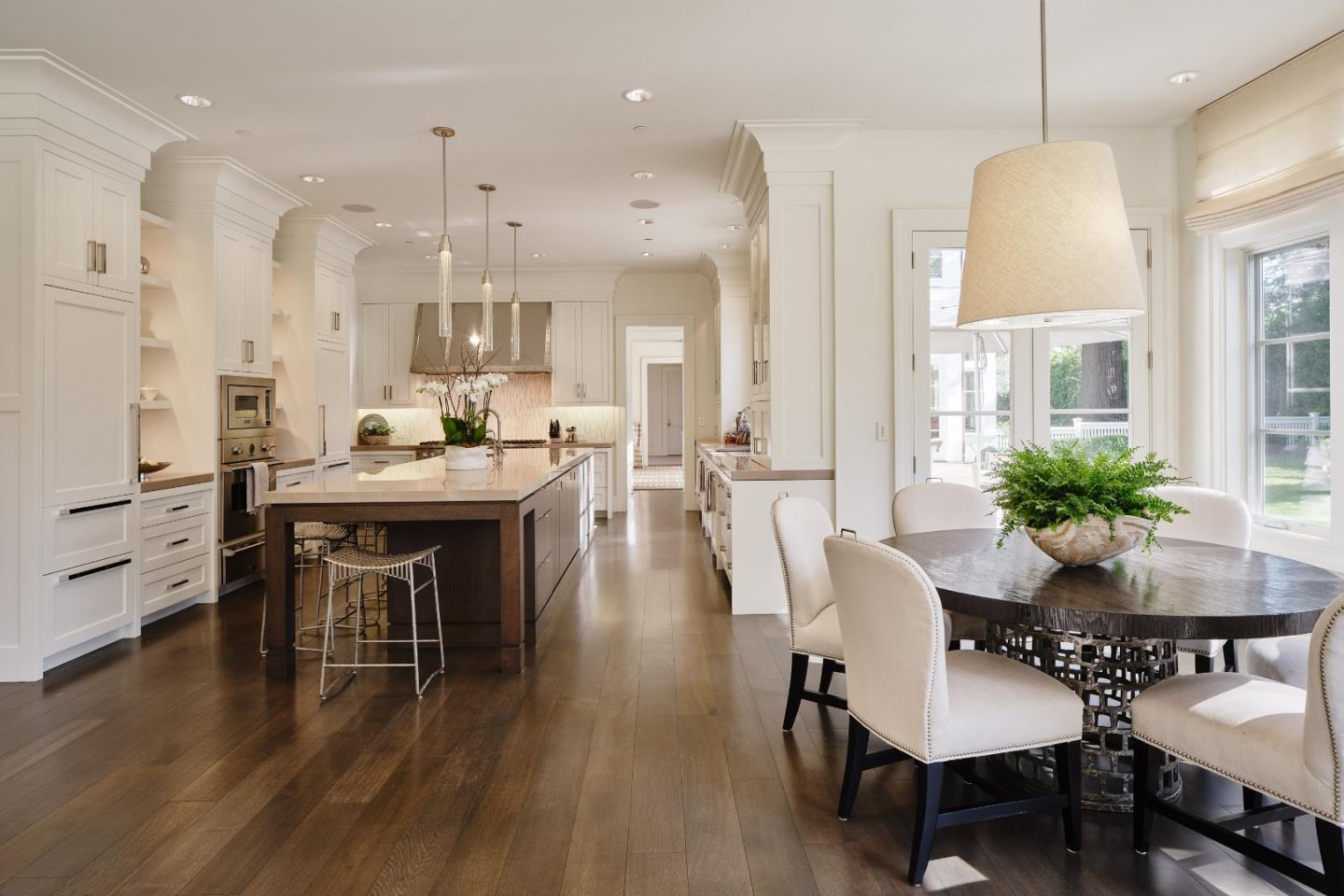 138 Almendral Avenue Atherton, CA 94027 - Photo 14 of 44 a dining room with wooden floor a chandelier a glass table and chairs