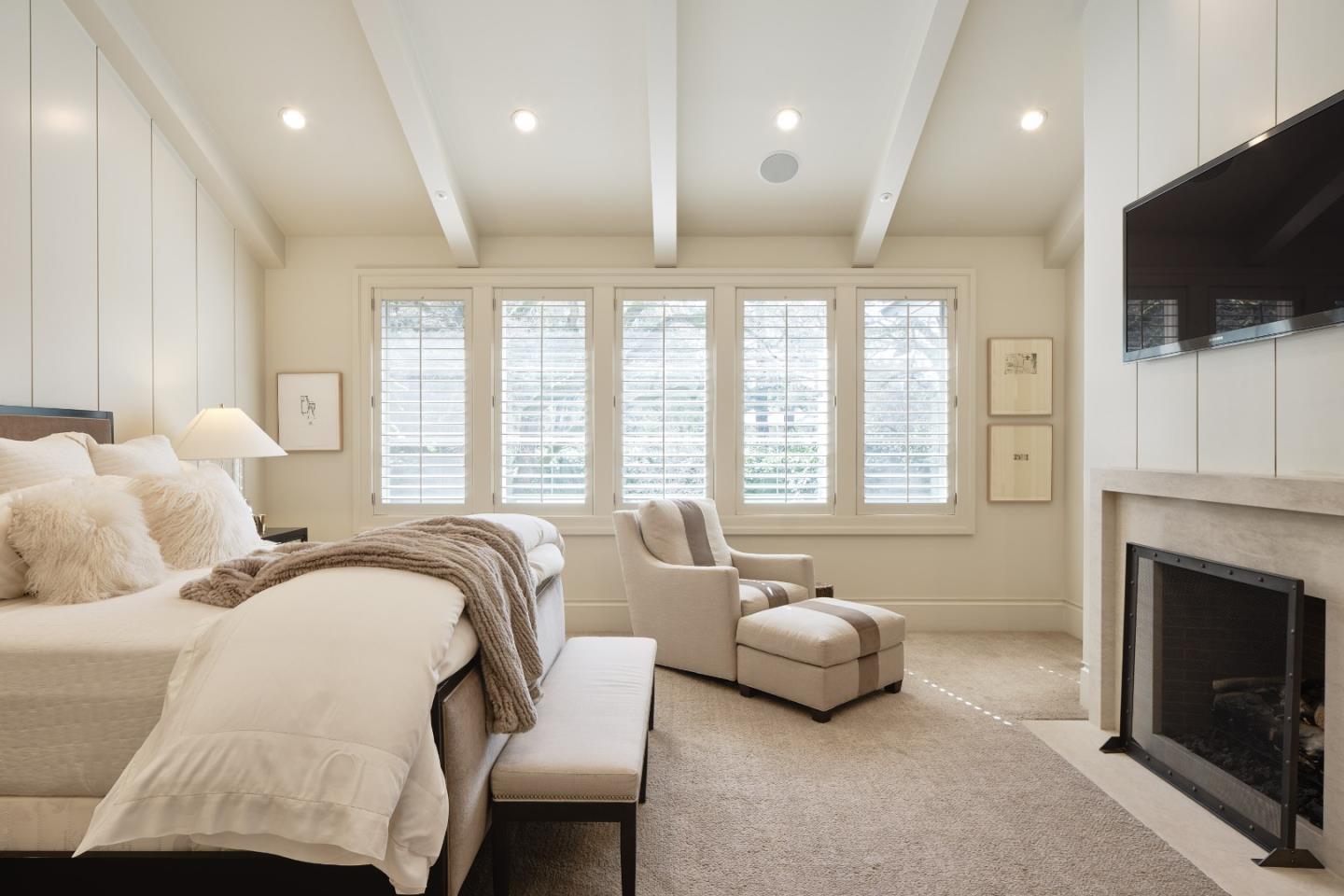 138 Almendral Avenue Atherton, CA 94027 - Photo 21 of 44 a spacious bedroom with bed and a flat screen tv