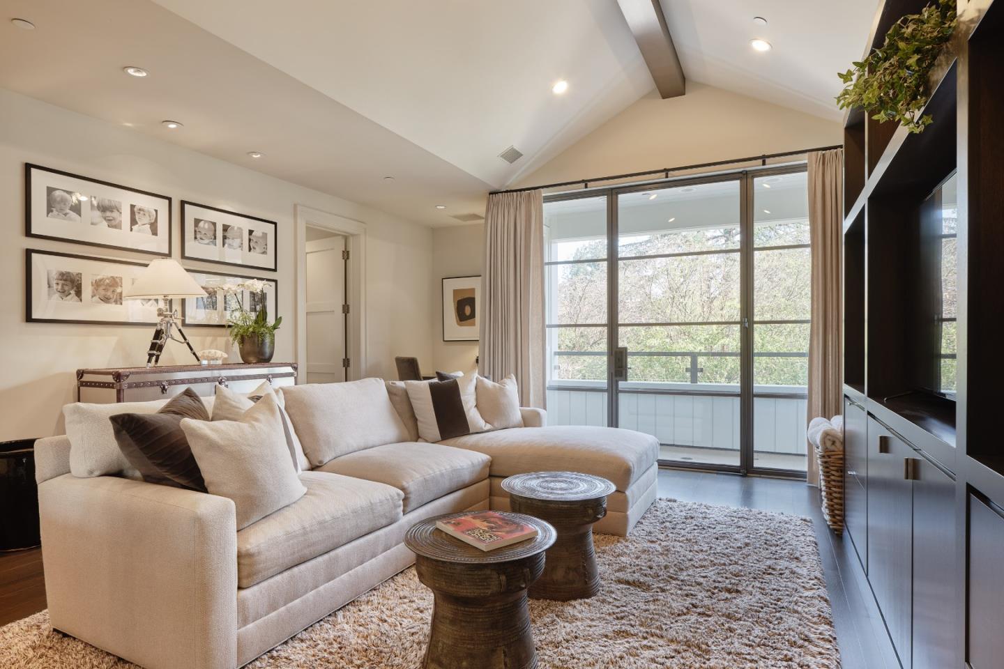 138 Almendral Avenue Atherton, CA 94027 - Photo 25 of 44 a living room with furniture a flat screen tv and a floor to ceiling window