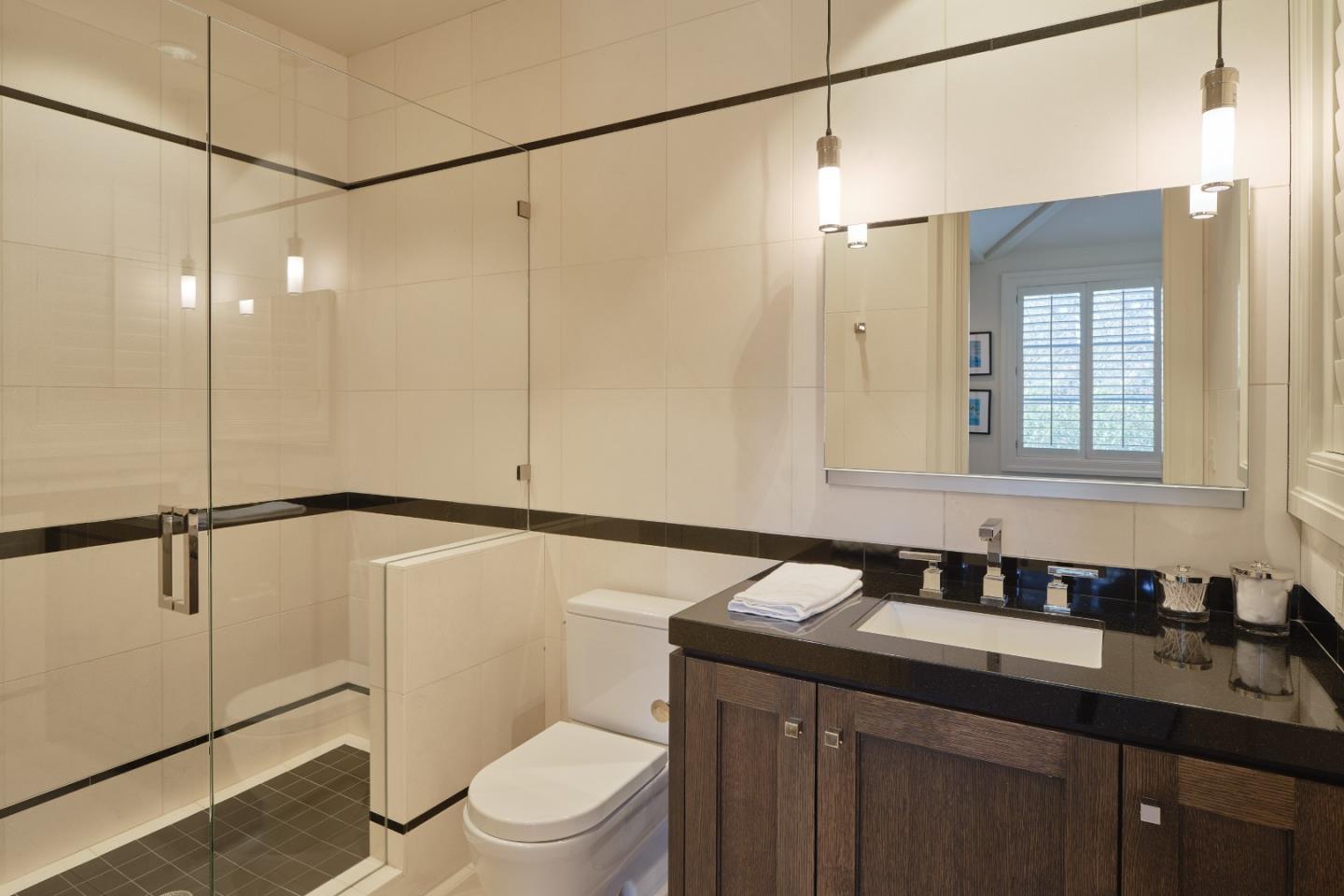138 Almendral Avenue Atherton, CA 94027 - Photo 30 of 44 a bathroom with a granite countertop sink mirror vanity and toilet