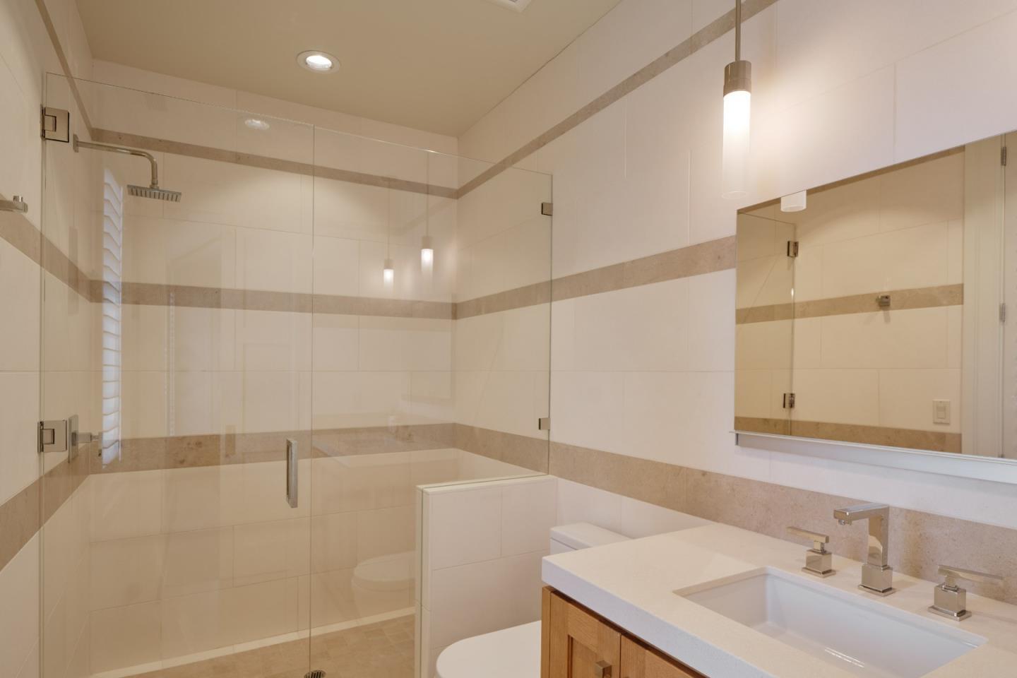 138 Almendral Avenue Atherton, CA 94027 - Photo 33 of 44 a bathroom with a granite countertop sink a toilet a mirror and shower