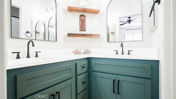 a bathroom with a double vanity sink mirror and