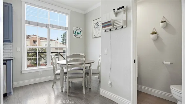 a view of a dining room with furniture window and wooden floor