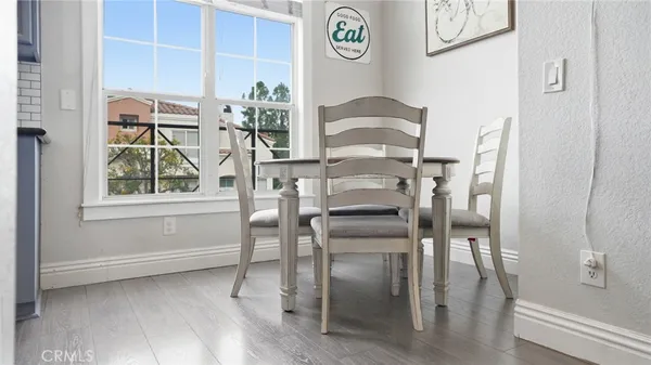 a view of a dining room with furniture window and wooden floor