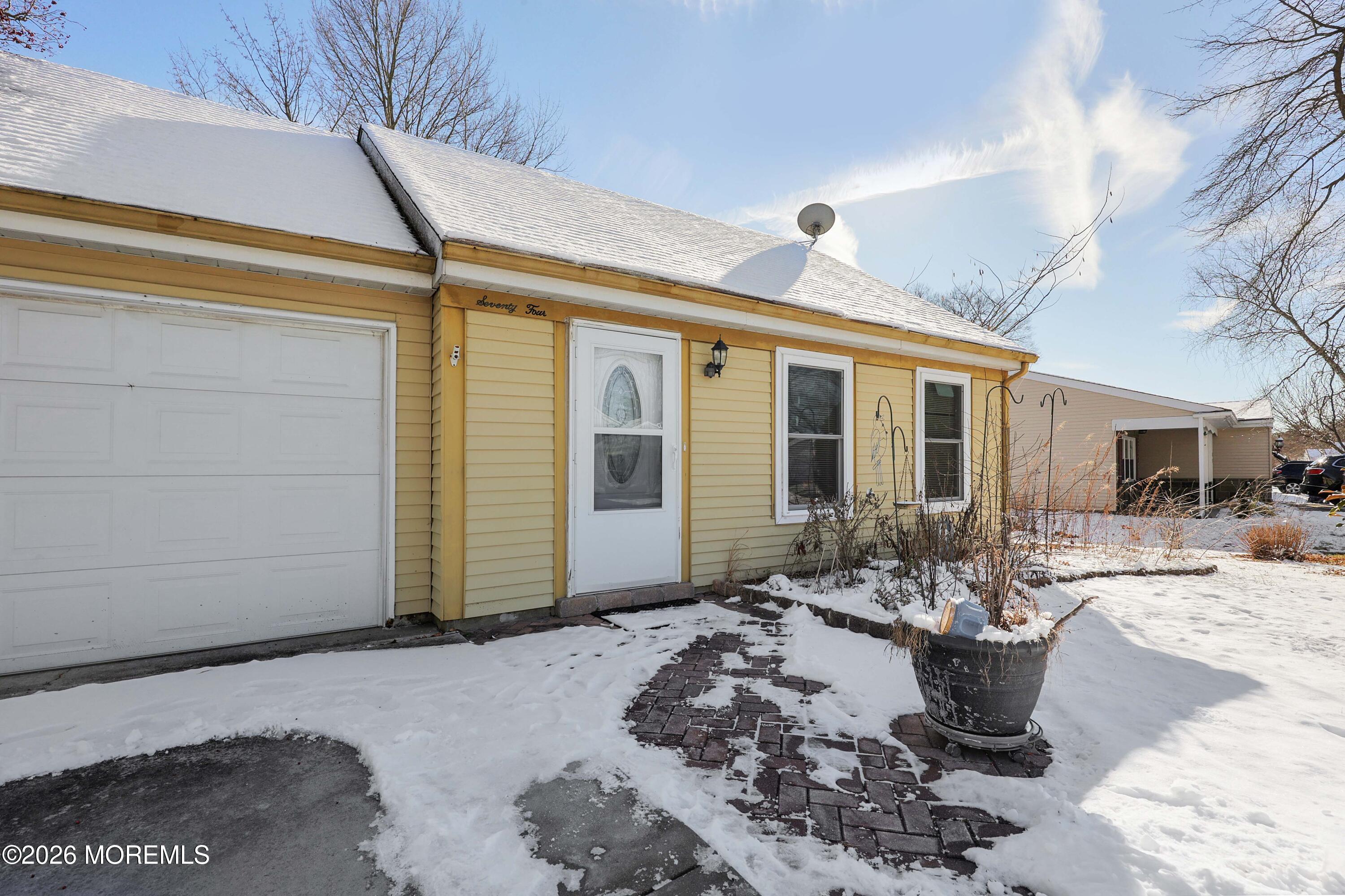 a view of a patio with couches table and chairs under an umbrella