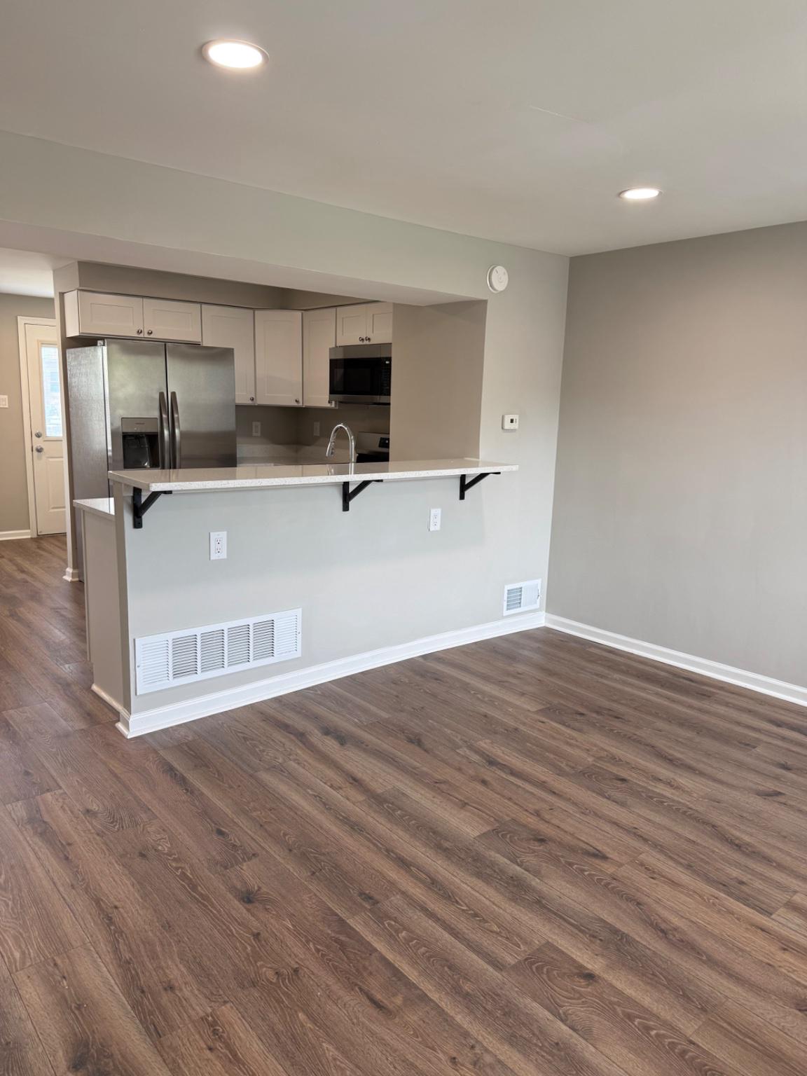 2908 Mallview Road Baltimore, MD 21230 - Photo 3 of 22 a view of kitchen with stainless steel appliances granite countertop a refrigerator a sink dishwasher a stove and white cabinets with wooden floor