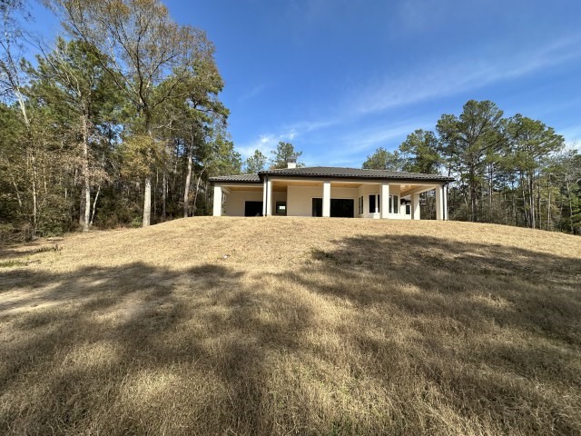 875 Lonestar Road Huntsville, TX 77340 - Photo 3 of 24 a view of a house with a yard