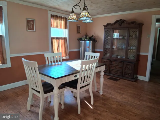 a kitchen with a refrigerator and a stove top oven