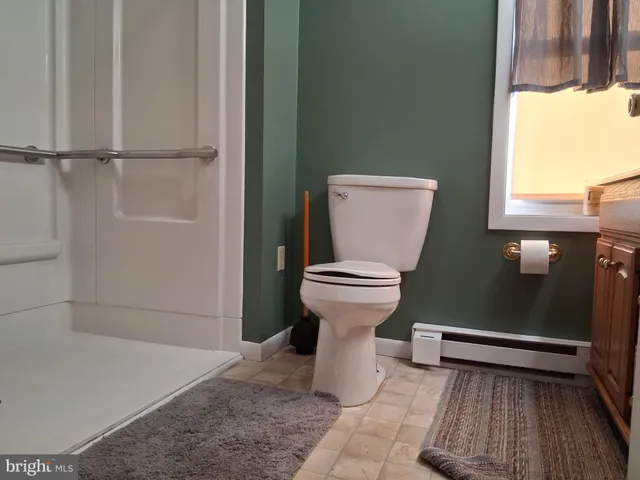 a bathroom with a toilet and a shower