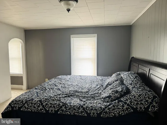 a bed room with bed and a window