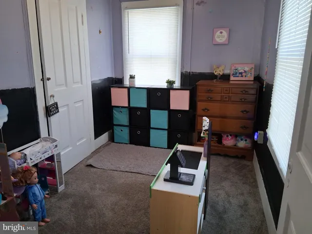 a bedroom with a bed and a tv