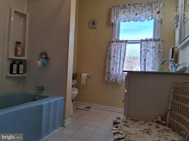 a view of a house with a yard and wooden fence