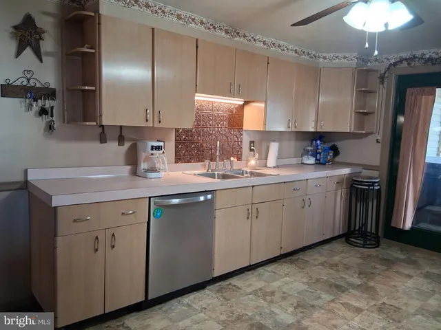 a kitchen with a sink cabinets and stainless steel appliances