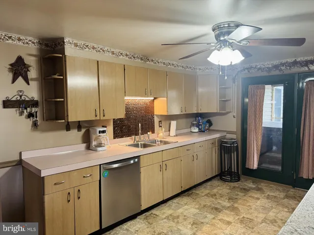 a kitchen with a stove a sink a refrigerator and a mirror