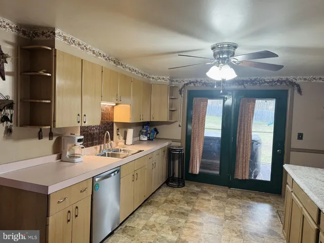 a dining room with furniture a chandelier and wooden floor