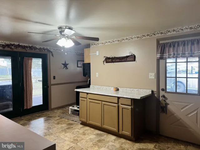 a dining room with furniture a chandelier and wooden floor